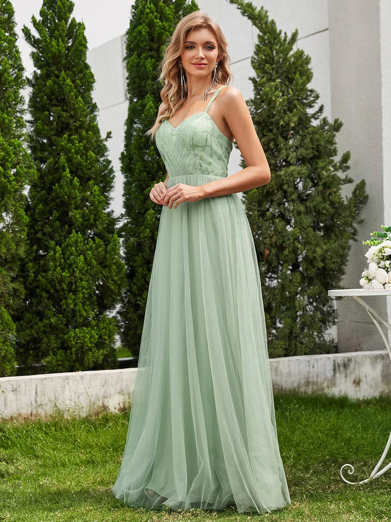 Mint green formal dress with spaghetti straps, lace up back and tulle skirt.